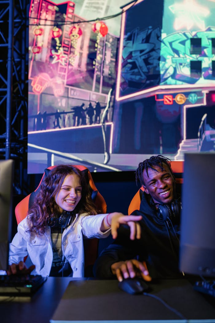 Two friends enjoying a video game session with colorful graphics in the background.